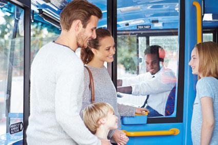 family boarding bus and buying ticket