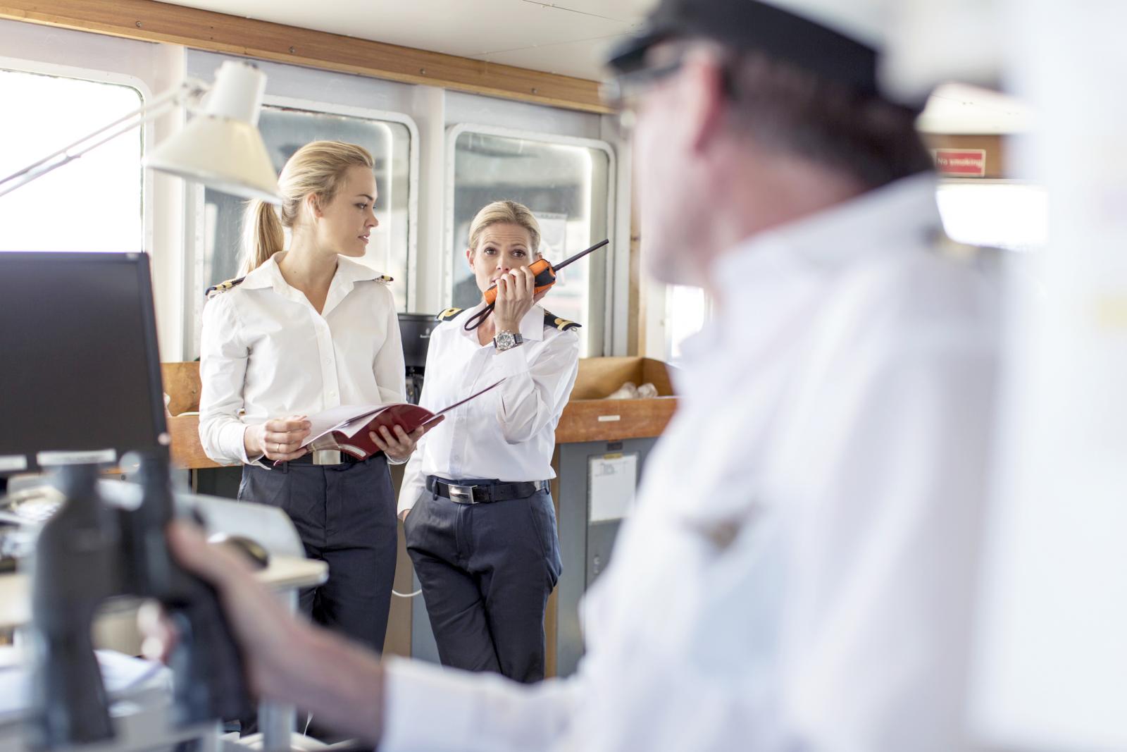 Deck officers and ship captain on bridge