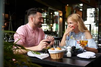 Couple laughing at restaurant table