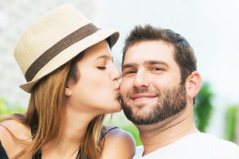 Woman giving her boyfriend a kiss on the cheek