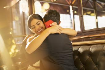 Woman hugging partner after receiving gift