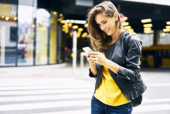 Happy woman looking at cell phone