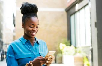 Smiling woman texting