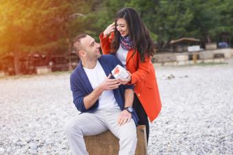 woman surprises her husband on beach