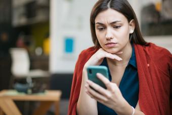 worried woman blocking contact on cell phone