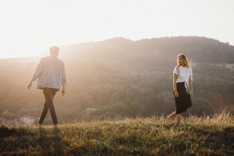 Boy and girl in love walking away from each other