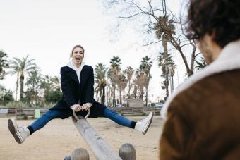 Woman being silly on a seesaw