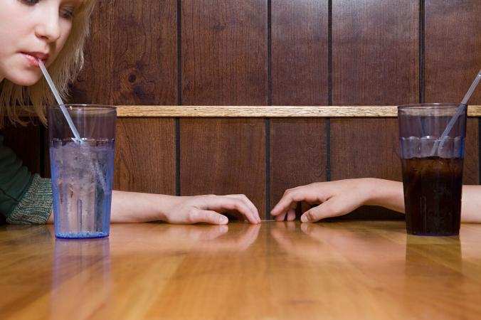 Teenage couple sitting in cafe