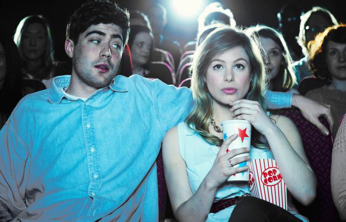 couple enjoying a movie at the cinema