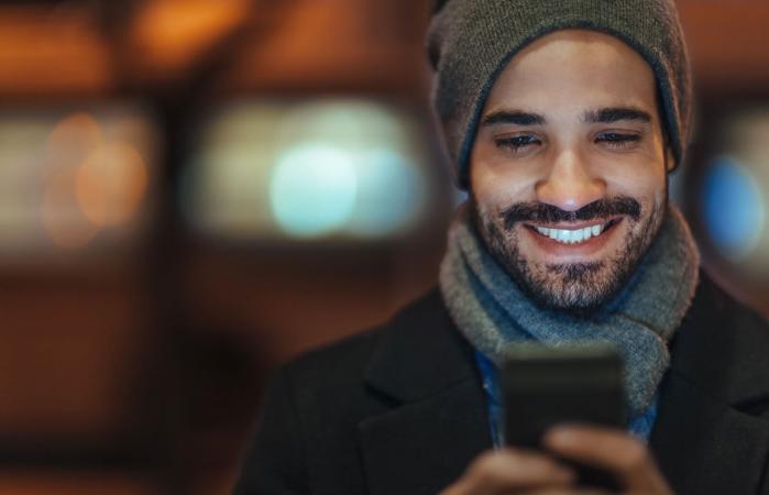 Young man sending text