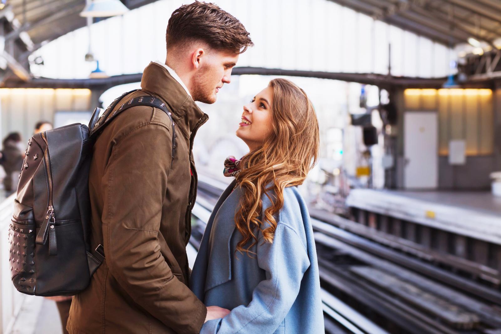 Long distance relationship, couple at train station saying goodbye