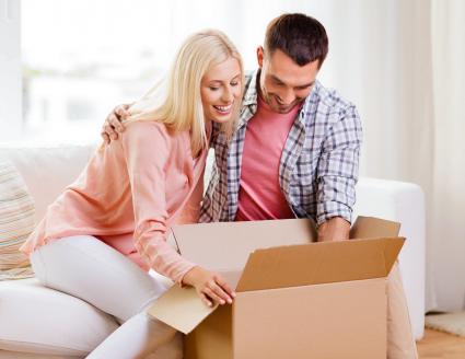 Couple opening box at home