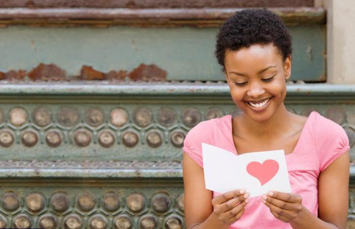 woman reading Valentine's Day card