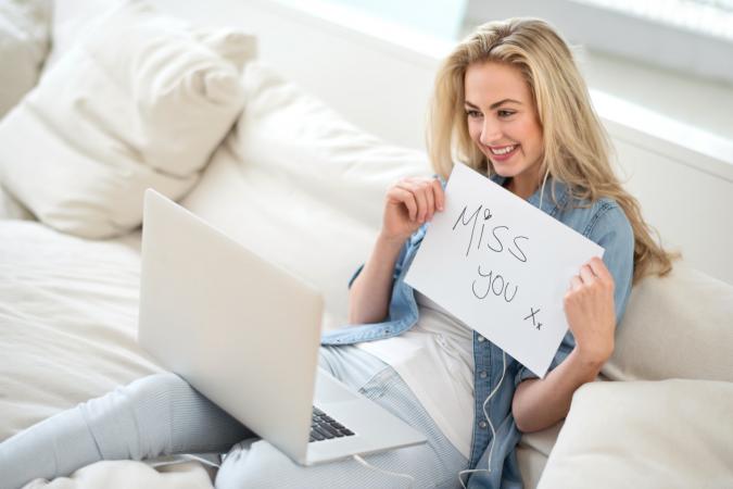 Woman video chatting with her distant boyfriend