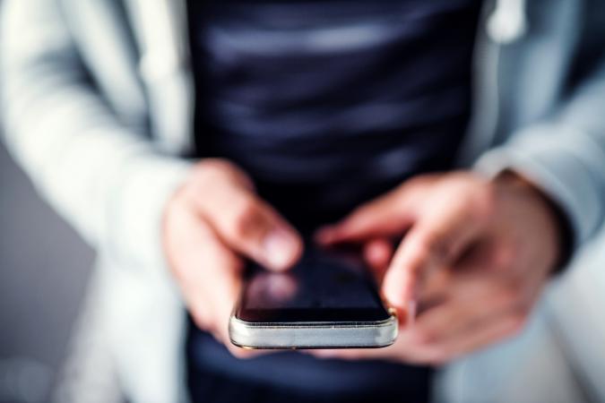 Man with smartphone texting