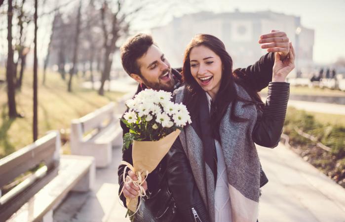 man giving woman flowers