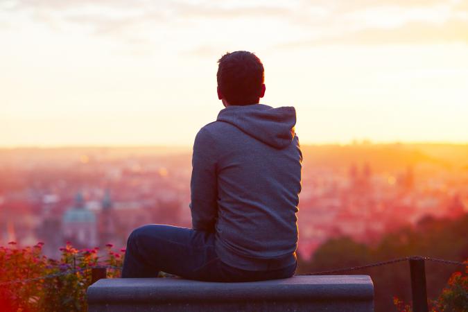 Young man looking at the sunrise