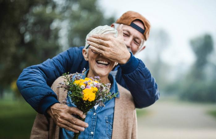 Man giving romantic flowers to wife