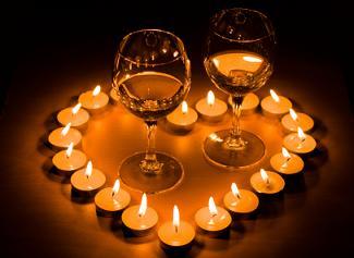 Wine glasses inside a heart of tealight candles