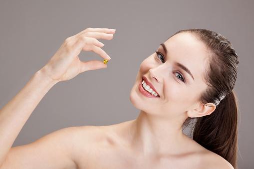 woman holding a capsule