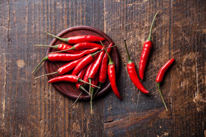 Plate of cayenne peppers/capsicum on table