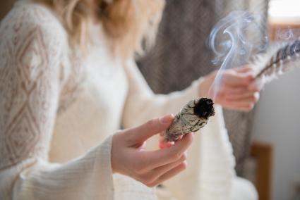 Woman holding burning sage
