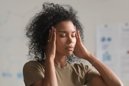 Massaging temples with peppermint oil