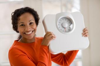 Happy Woman Holding Scale