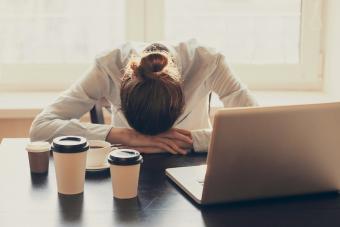 Exhausted woman at desk