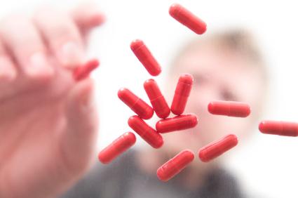 Man picking up a capsule
