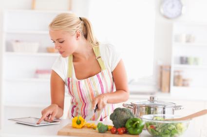 woman cooking with tablet