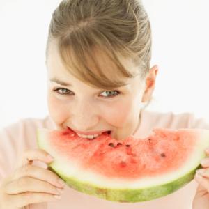 Pretty woman eating watermelon