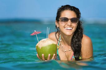 Woman drinking from a coconut