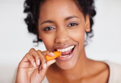 woman eating carrot stick
