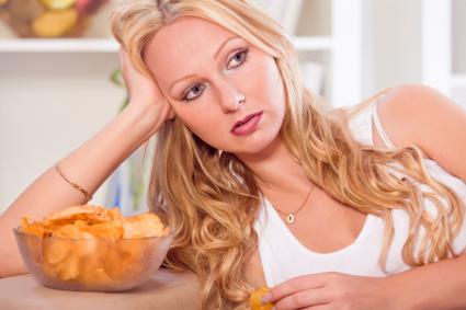 Unhappy woman with chips