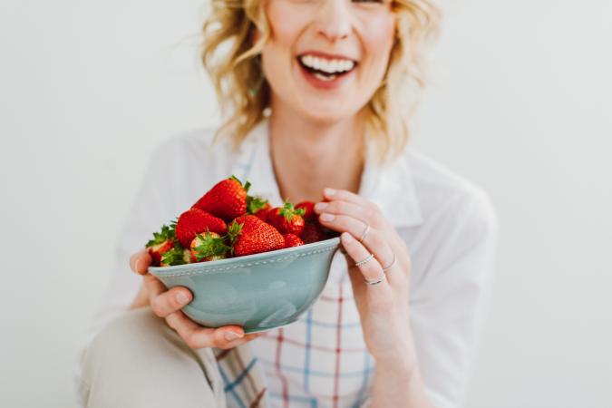Woman with bowl of strawberries