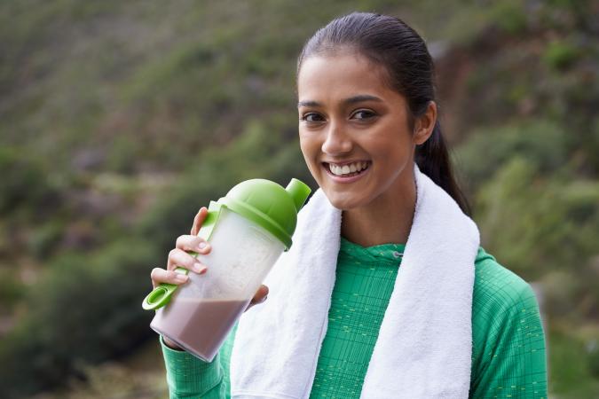 woman drinking a sports drink