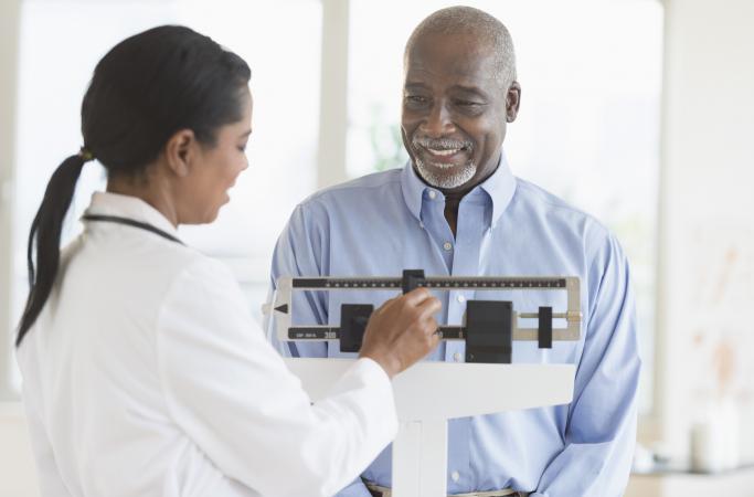 doctor weighing patient