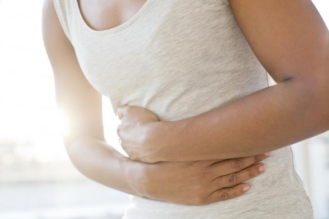 adult woman holding stomach