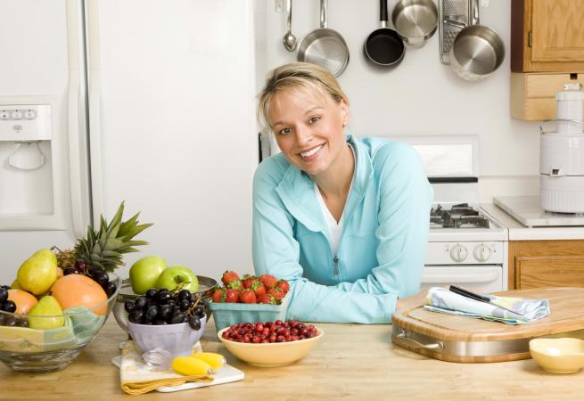 Woman in kitchen with fresh produce