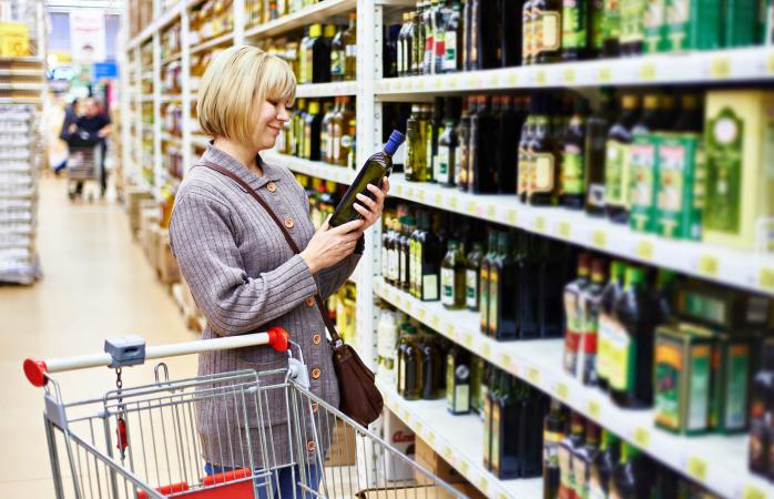 Woman shopping for olive oil