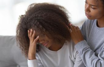 Mom comforting sad teenage daughter