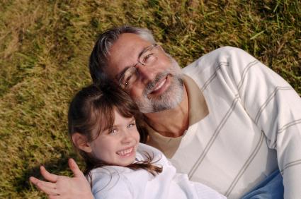 Grandfather and grandchild on grass