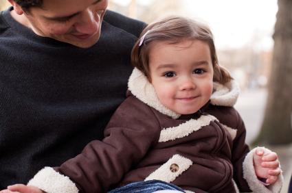 Father holding smiling daughter