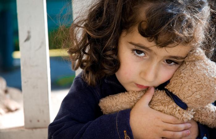 Sad Little Girl holding a Teddy bear