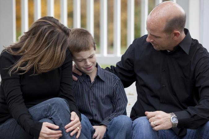 Parents consoling son