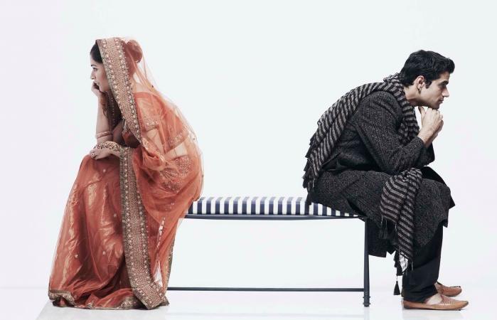 couple sitting on opposite ends of a bench