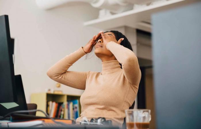 Frustrated woman with head in hands