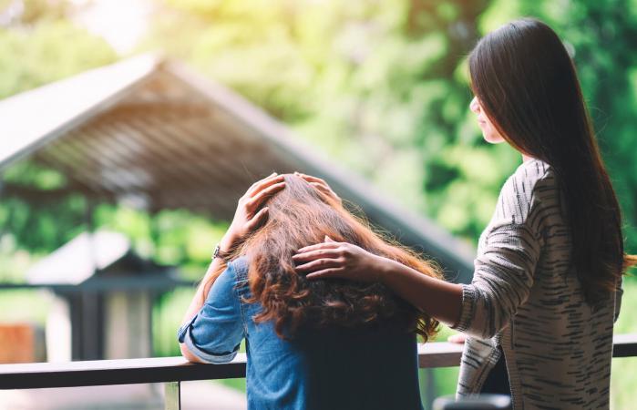 Woman consoling sad friend
