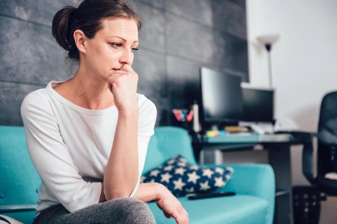 Sad woman on blue couch